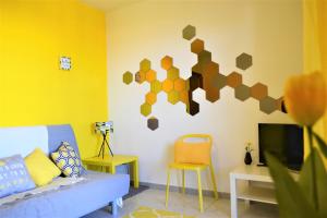 a living room with a couch and a tv at Casa Vacanze Mura in Cala Gonone