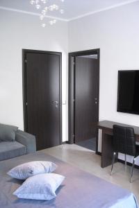 a room with a bed and a desk and a television at B&B Il Granello Di Senape in Rome