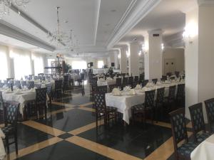 a banquet hall with white tables and chairs at Hotel Colaiaco in Anagni