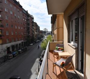 a balcony with chairs and a view of a street at B&B Acasadibarbara in Rome