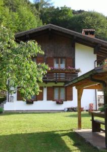 a house with a balcony on top of it at Chalet Monica in Molina di Ledro