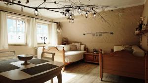 a bedroom with a bed and a table and a dining room at Gästehaus Liebler in Rothenburg ob der Tauber