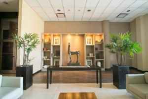 a lobby with a table with a horse statue on it at Hotel Tower Inn & Suites in San Rafael