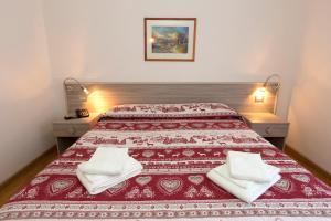Postel nebo postele na pokoji v ubytování Hotel Cima Tosa