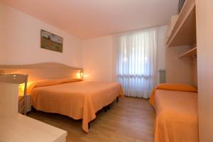 Postel nebo postele na pokoji v ubytování Hotel Cima Tosa