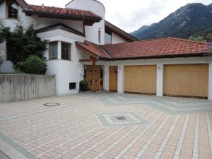 a house with two garage doors and a driveway at Haus Salzmann in Pfunds