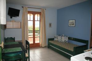 a living room with a bed and a balcony at Panorama in Lixouri