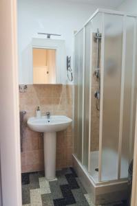 a bathroom with a sink and a shower at Aretè Guest House in Siracusa