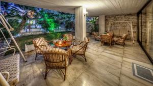 a patio with a table and chairs on a porch at Zina Hotel Apartments in Athens