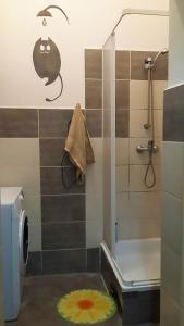 a bathroom with a shower and a toilet and a rug at Art Hostel in Kraków +53 photos