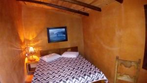 En eller flere senge i et værelse på Pedra Escondida