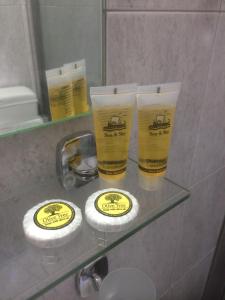 two cups sitting on a glass shelf in a bathroom at Platanos Rooms in Anopoli Sfakion