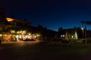 a street at night with lights on a building at Platanos Rooms in Anopoli Sfakion