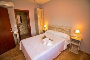 a hotel room with two beds and a bathroom at Casa Codeta in La Almunia de San Juan