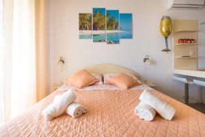 a bedroom with a bed with towels on it at Apartments Rakuljic in Podstrana