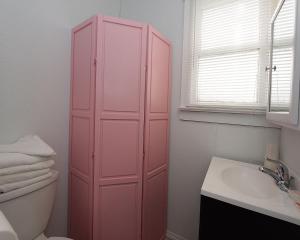 a pink cabinet in a bathroom with a sink at Shore Beach Houses - 38 D Lincoln Avenue in Seaside Heights +7 photos