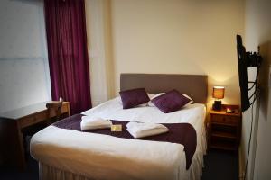Una habitación de hotel con una cama con dos almohadas. en 72QT en Londres