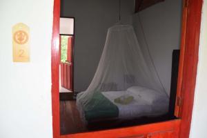 Postel nebo postele na pokoji v ubytování Finca San Rafael - Cafe y Cacao