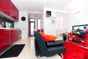 a living room with a black chair and a television at Ana's Design Apartments in Lisbon