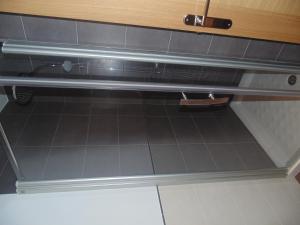 a kitchen with a black tiled floor and a drawer at Hotel Ribera de Langa in Langa de Duero