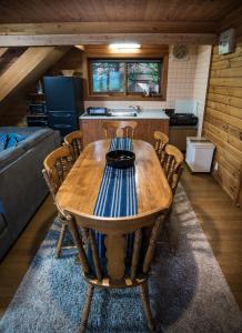 a wooden table and chairs in a room at Balls Deep Inn Villas in Hakuba