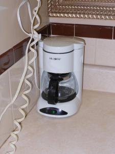 a coffee maker sitting on a counter next to a wall at McClellan Inn in Anniston