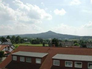 a view of a mountain from the roofs of houses at Hotel Oelberg budget - BONN SÜD Königswinter in Königswinter