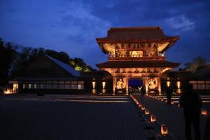 a large building with a tower at night at H-SEVEN TOYAMA (Adult Only) in Takaoka