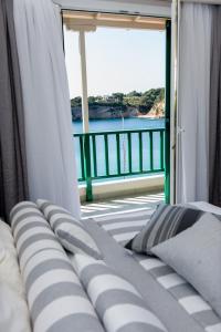 Ce lit se trouve dans un dortoir offrant une vue sur l'océan. dans l'établissement Alkyon Hotel, à Patitiri