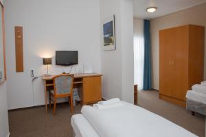 a hotel room with a bed and a desk with a computer at Trip Inn Goethe Hotel Messe Frankfurt in Frankfurt