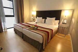 Postel nebo postele na pokoji v ubytování Hotel San Gil