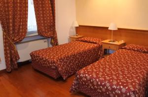 Postel nebo postele na pokoji v ubytování Gorizia Inn