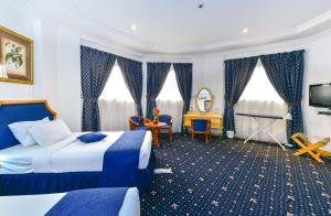 Ένα ή περισσότερα κρεβάτια σε δωμάτιο στο Cayam Hotel
