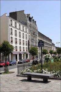 a park bench in front of a large building at Villa Lutèce Port Royal in Paris