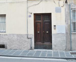 a wooden door on the side of a building at Casetta in citta'- Seancity in Lucca