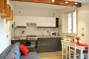 a kitchen and living room with a couch and a table at Casetta in citta'- Seancity in Lucca
