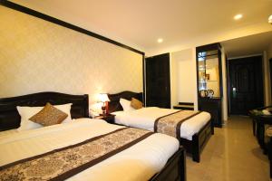 Letto o letti in una camera di Royal Dalat Hotel