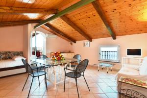 a living room with a table and chairs and a bed at La Ciucciara Holiday Homes in Massa Lubrense +33 photos
