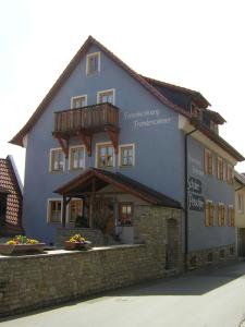 a large building with a balcony on the side of it at Schuler-Petschler in Obereisenheim