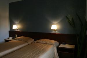 Postel nebo postele na pokoji v ubytování Hotel Forum