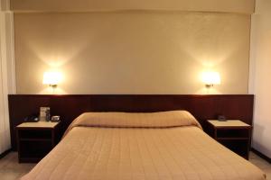 Postel nebo postele na pokoji v ubytování Hotel Forum