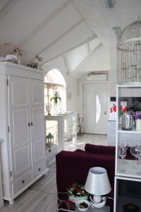 a living room with a couch and a white cabinet at Art apartman in Kakanj