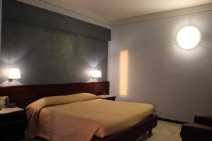 Postel nebo postele na pokoji v ubytování Hotel Forum