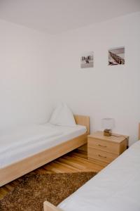 1 dormitorio con 2 camas y mesita de noche en Frühstückspension Scharinger Hof, en Gilgenberg am Weilhart