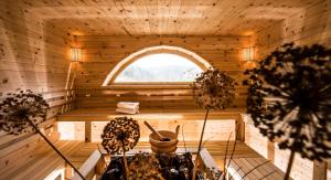 an inside of a wooden sauna with a window at Gartenhotel Völser Hof - Adults Only in Völs am Schlern