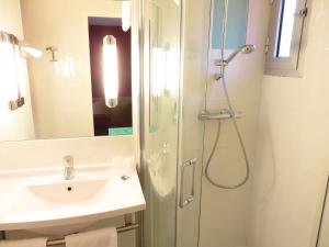 a bathroom with a shower and a sink at Mercure Hexagone Luxeuil in Luxeuil-les-Bains +14 photos