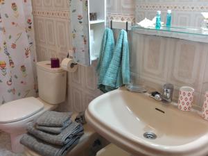 a bathroom with a white sink and a toilet at THE HAPPINESS PENTHOUSE Dream Holiday at 100m Beach in Candelaria +207 photos