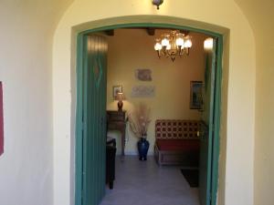 an open door into a living room with a couch at Villa De Loulia in Peroulades