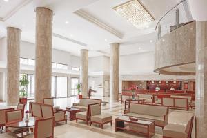 a lobby of a hotel with tables and chairs at Makarem Mina Hotel in Makkah