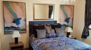 
a bed room with a painting on the wall at One Strathview B&B in Forfar
